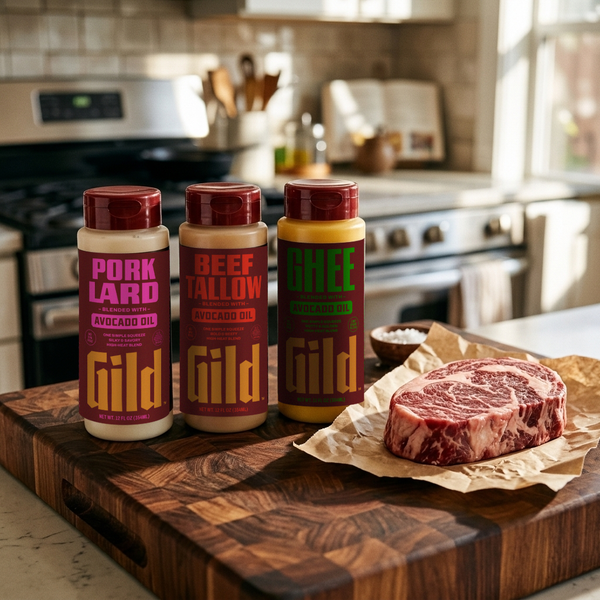 GILD Beef Tallow, Pork Lard and Ghee squeeze bottles on a butcher block